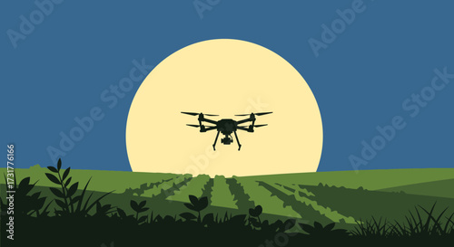 Silhouette of a drone flying over a field at sunset.