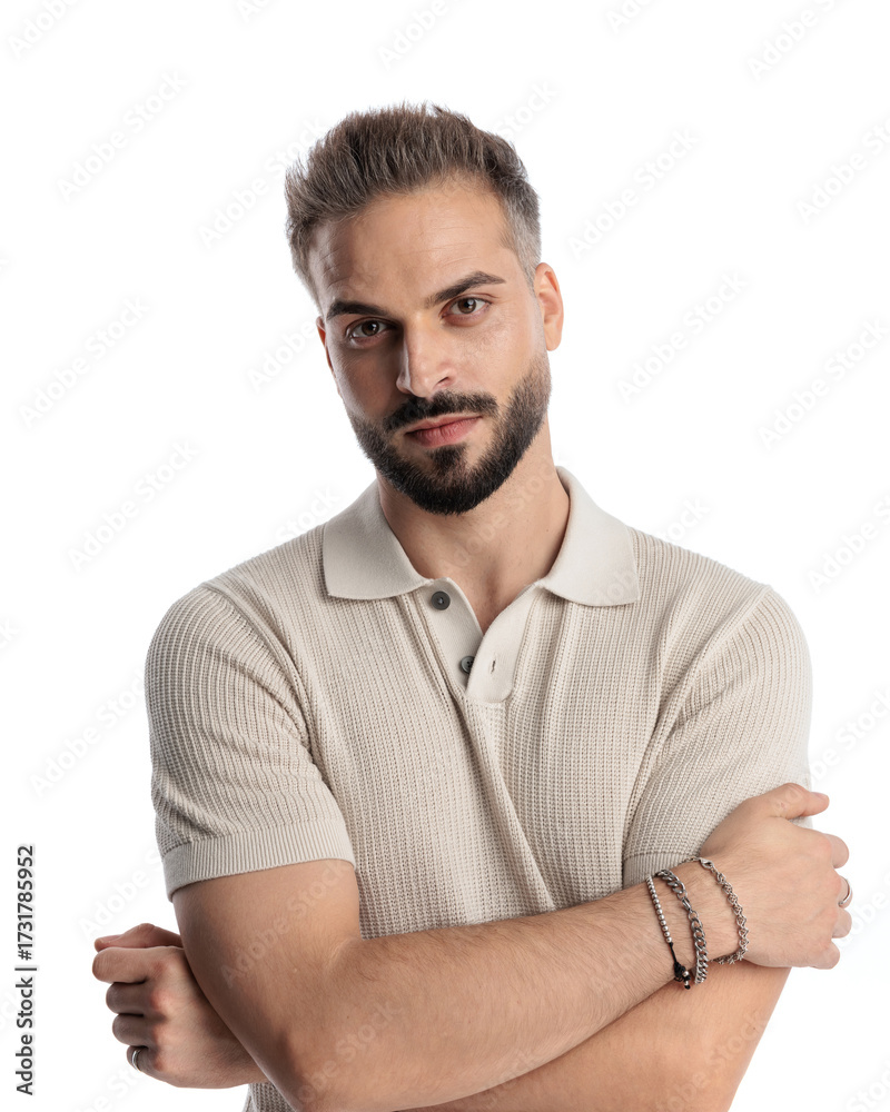 Obraz premium sexy young guy in polo shirt crossing arms and looking forward