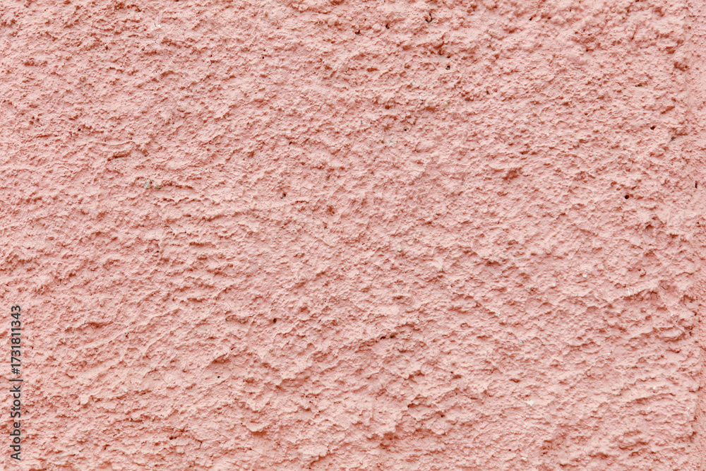 Fototapeta premium A pink wall with a textured surface
