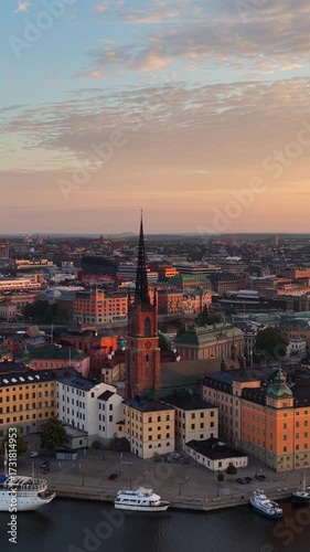 Stockholm vertical aerial video at sunrise, drone flying above Stockholm old town in the morning