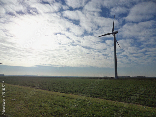 Wind turbine in the field. Nature backdrop. Beautiful natural flyer, card design. Nature Template for presentation or product