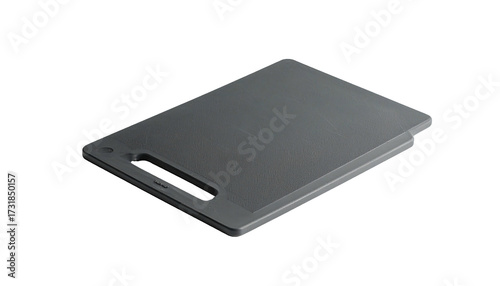 A rectangular, gray kitchen cutting board with a handle, angled against black