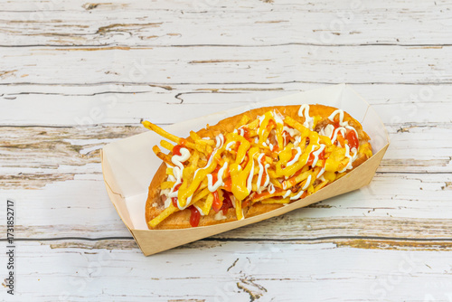 Full Chilean hot dog with mashed avocado, diced tomatoes, sauerkraut, and homemade mayonnaise, served on special hot dog buns