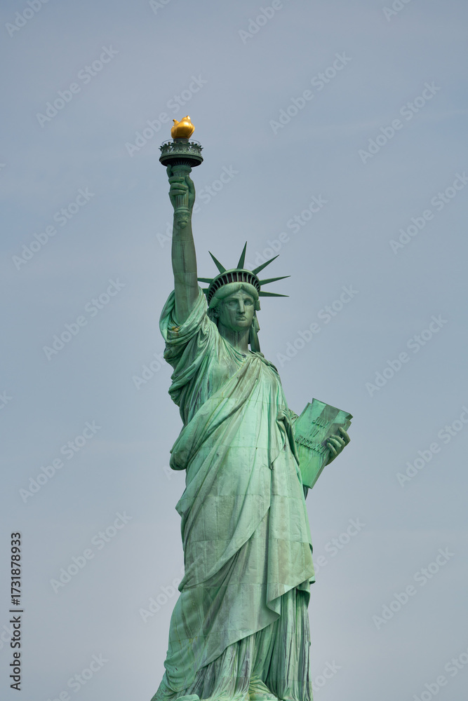 Obraz premium Wide-angle shot of the Statue of Liberty as seen from ferry cruising through New York Harbor