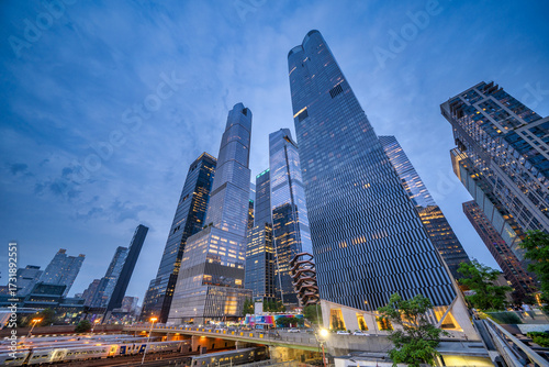 New York City - June 13, 2025: Nighttime perspective of High Line with visitors walking and modern Hudson Yards architecture