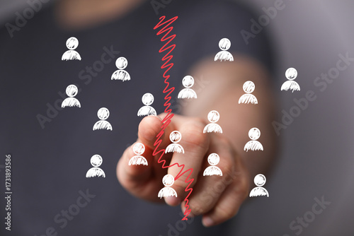 Schilderij op canvas Image depicting a hand separating groups of people, symbolizing division, conflict, or team split