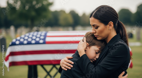 Mourning death loss, grieving woman and child embracing by casket draped with American flag at cemetery, in moment of grieving death loss. Grieving death loss represents sorrow,