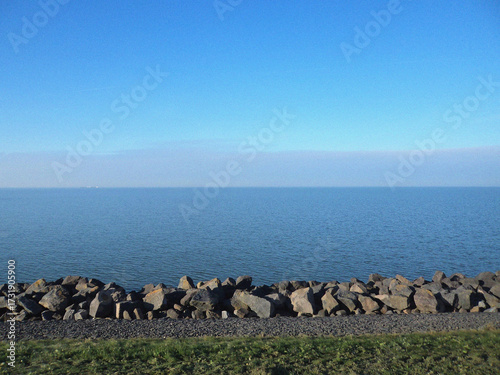 Sea with blue sky and stones. Beautiful natural flyer, card design. Nature Template for presentation or product