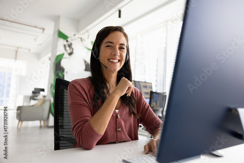 Positive sales representative in headset engaged in online meetings