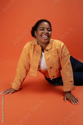Wallpaper Mural Stylish plus size african american woman showcases trendy autumn outfit in studio Torontodigital.ca