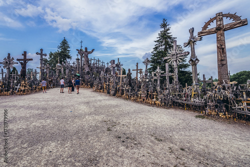 Tourists on Kryziu kalnas - Hill of Crosses - famous pilgrimage site near Siauliai city in northern Lithuania