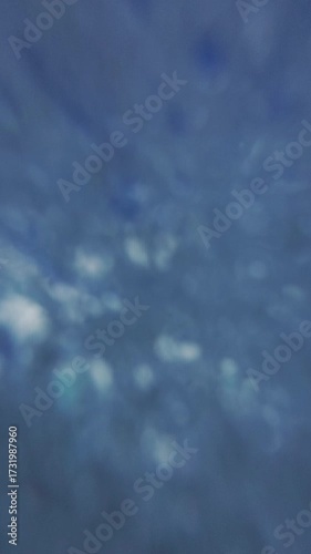 Slo-mo handheld PPV footage of rushing sea wave breaks over action camera. First POV of splashing waves. Above and under water