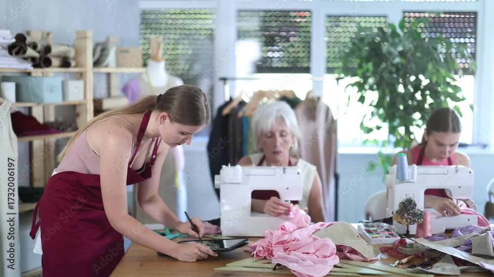 Video Stock Female tailor create sketch of dress on tablet, draw and ...