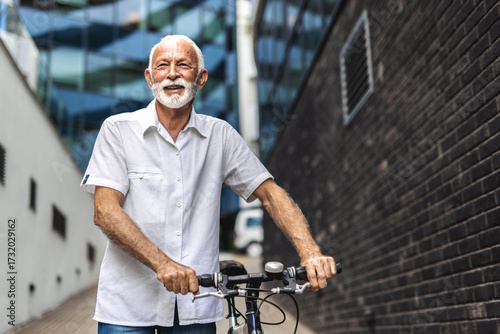 Portrait, business and mature man with bike, travel and confident with background, startup and eco friendly.. Businessman commuter pushing his bicycle on the street on his way to work.