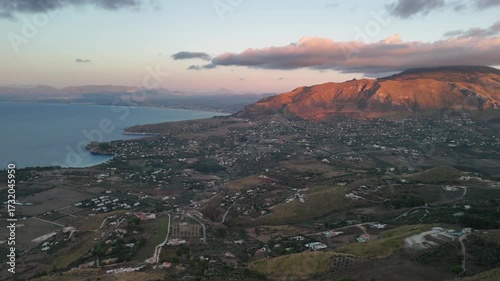 Aerial view of coastal city and sea during sunset in Sicily, Italy