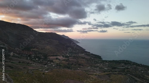 Scenic coastal landscape with ocean, cliffs and sunset sky in Sicily, Italy