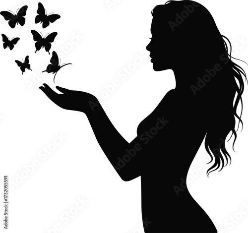 Silhouette of a woman releasing butterflies from her hands