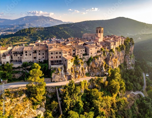Picturesque mountain village nestled in a valley, surrounded by lush greenery and dramatic cliffs. Golden hour light bathes the scene