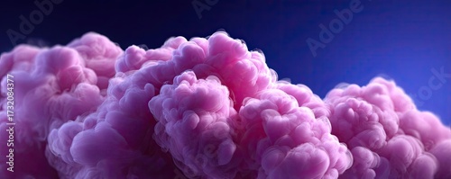 Puffs of pink smoke on blue background concept. Vibrant pink clouds against a deep blue background.