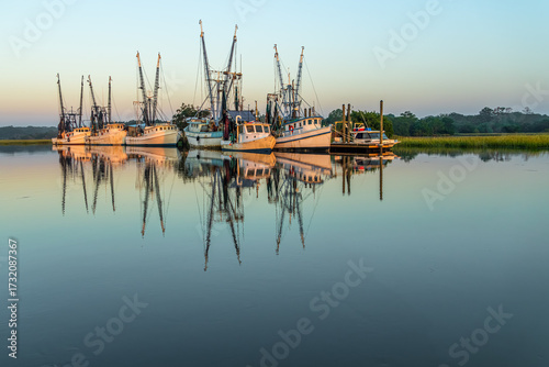 Shrimp boats docked in a cove at sunrise