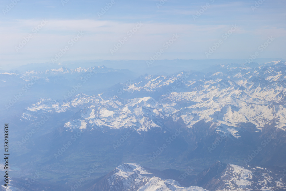 Naklejka premium A bird view over the French Alps and the Provence-Alpes-Cote d'Azur region in the south of France. The top of the mountain range is still covered with some parts of snow at the start of April.