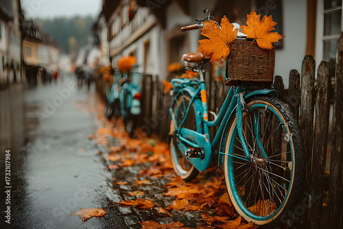 Vintage Bicycle with Autumn Leaves in a Rainy Village Street Setting