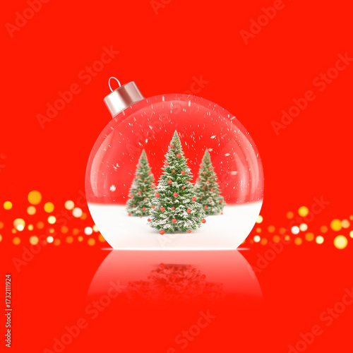 Christmas ball ornament with snowy trees inside on red background. Stock photo.
