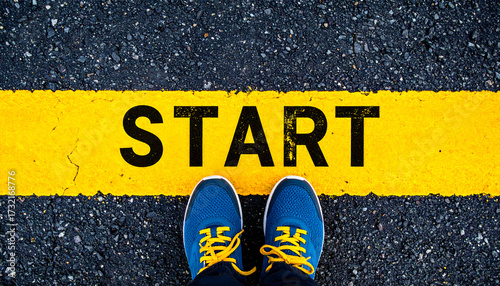 A pair of running shoes standing at the yellow start line, symbolizing new beginnings and motivation.