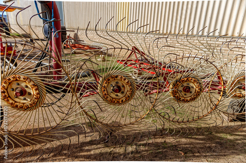 Old style wheel hay rake for moving hay into windrows for baling in the Little Karoo, near Oudtshoorn, Western Cape, South Africa