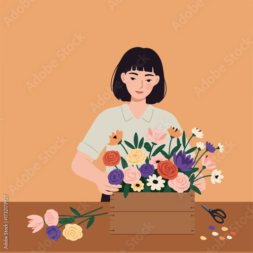 Woman arranging colorful flowers in wooden box, scissors and trimmings aside