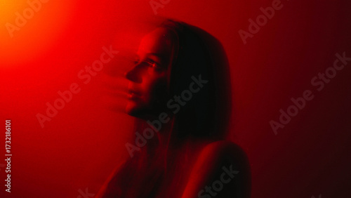 brunette portrait in Red color  with blurry long exposure technique 
