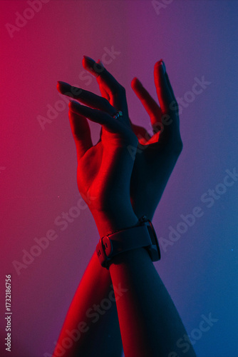 A person's hand reaching for something in the dark.