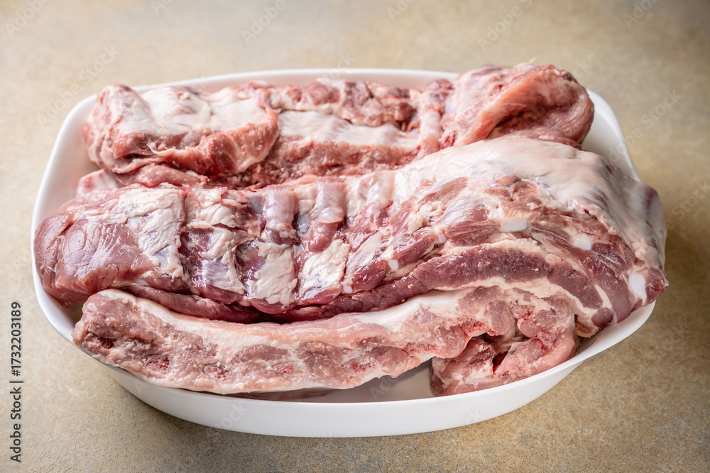 Fototapeta premium Raw pork ribs on white plate
