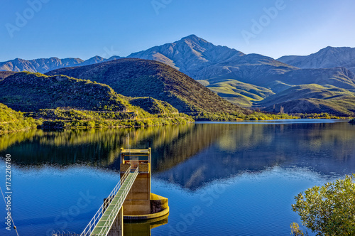 Koos Raubenheimer dam in the Little Karoo with water extraction tower serving the town of Oudtshoorn, Western Cape with Swartberg Mountain backdrop