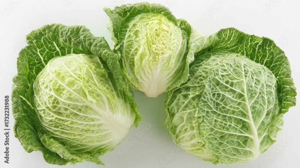 Fototapeta premium a close up of three fresh heads of cabbage, each with distinct ridges and textures that indicate their crispness