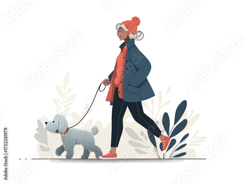 A woman strolls through a park with her fluffy dog on a leash. She wears a bright coat and a colorful beanie, enjoying the fresh air and nature.