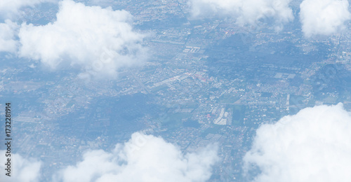 Beautiful landscape view trough window of airplane and cloudless sundown sky behind window of aircraft during flight. blue sky. Flying in the sky and the sea of clouds.