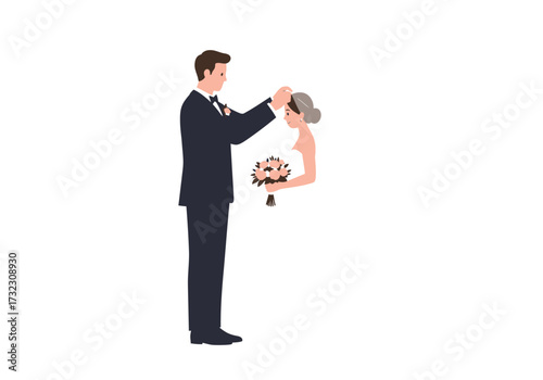 A groom adjusts the veil of his bride who carries a bouquet of flowers