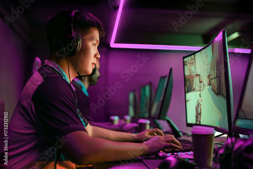 Obraz na plátně A dedicated gamer immersed in esports, showcasing enthusiasm in a vibrant neon a