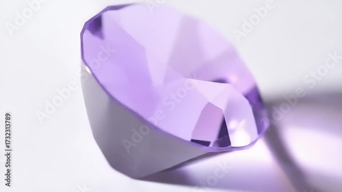 Vibrant purple gemstone with faceted surface on white background