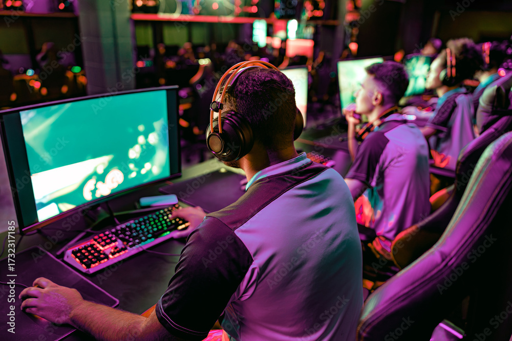Fototapeta premium Gamers are actively engaged in competitive play at a vibrant esports venue that is full of excitement and energy