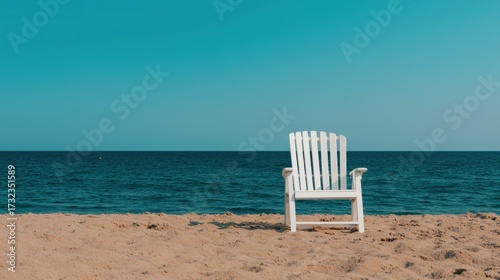 Serene Beach Scene with White Chair Against Clear Blue Sky and Calm Ocean Waves