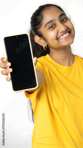 young woman holding a mobile phone, young woman with mobile phone, Young Indian woman presents blank smartphone screen. Happy girl shows device with empty display. Modern tech, app, design, advertisin