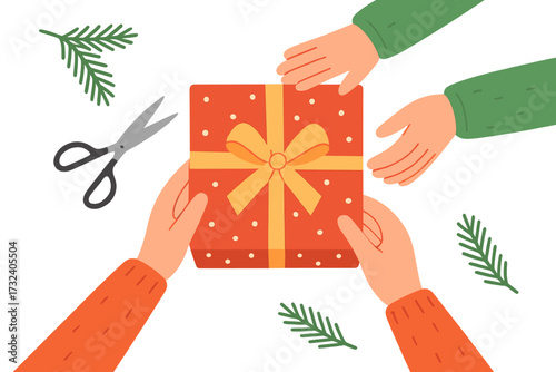 Two pairs of hands wrapping Christmas gift box on table with scissors and evergreen branches, festive holiday preparation for Christmas Eve and New Year celebration, top view