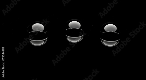 Three abstract spheres in a dark environment creating a sense of simplicity and modern design with a clean and focused composition