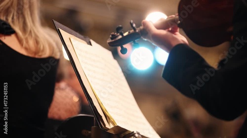 Unrecognizable violin player performing in orchestra ensemble 