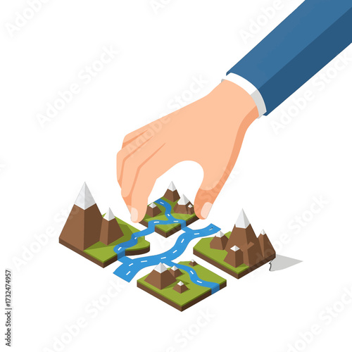 Hand arranging landscape elements creating a scenic environment.