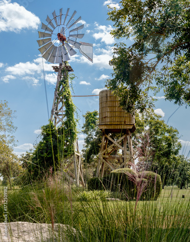 old windmill in the countryside next to water tank
