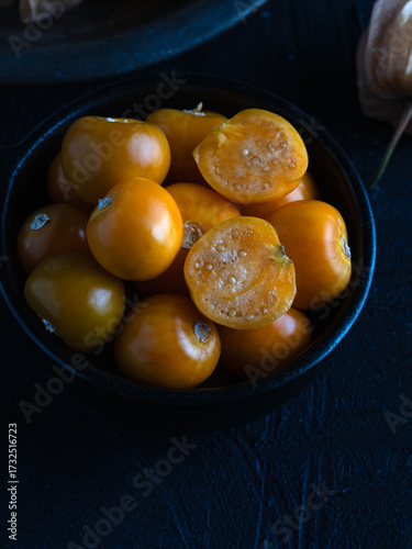 Fresh Golden Berries in Black Bowl on Dark Background