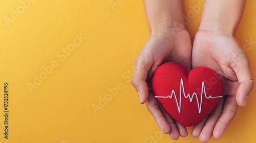 A pair of hands holds a red heart with a heartbeat line, set against a bright yellow background, symbolizing love and health.